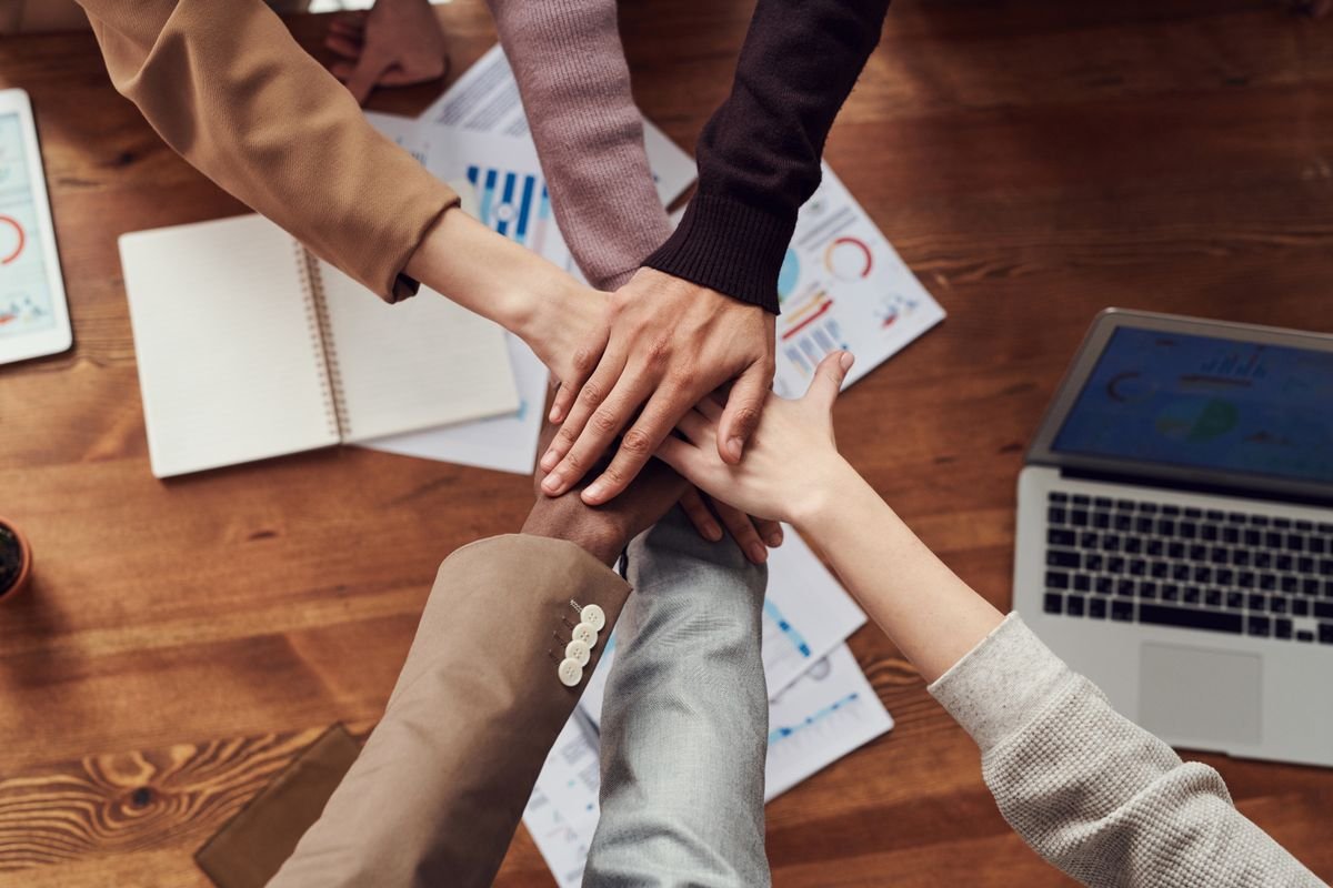 New business partners stacking hands over company plans